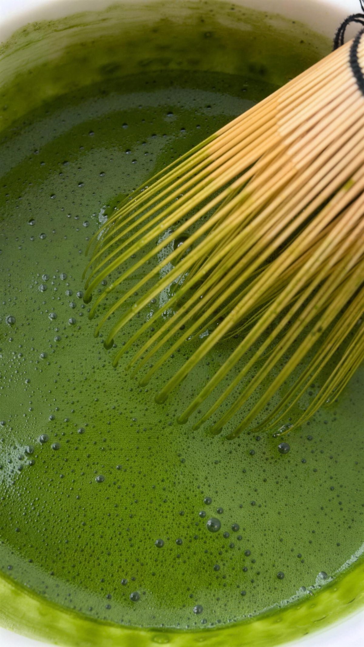 Bamboo whisk in bright green matcha